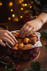 Kids hand tacke christmas cookies. close-up. New year treat for Santa Claus cooking. Homemade bakery, xmas sweet, winter holidays concept
