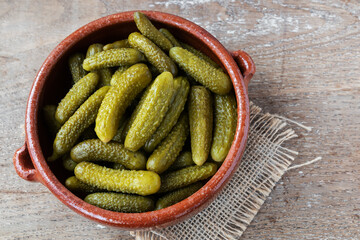 Pickled gherkins on rustic background