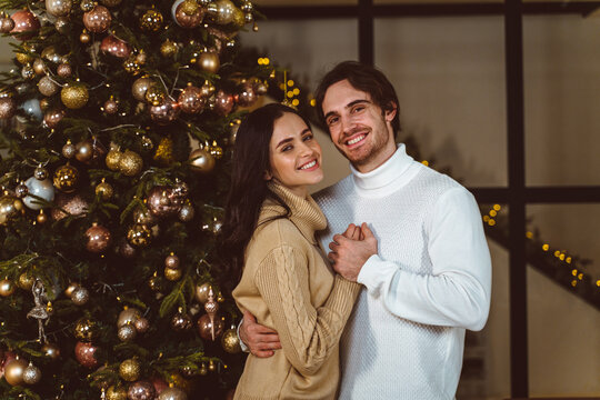 Cinematic image of a couple celebrating christmas at home.