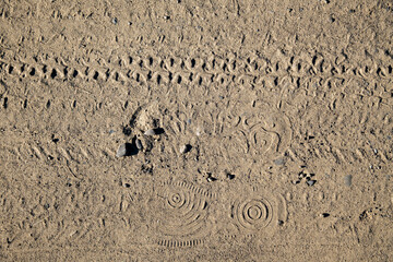 Natural sand stone texture background. Sand texture from heap of sand. Traces of the protectors of heavy industrial machinery on white sand. Background.
