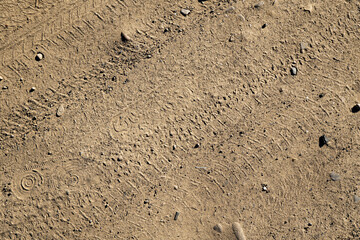 Natural sand stone texture background. Sand texture from heap of sand. Traces of the protectors of heavy industrial machinery on white sand. Background.