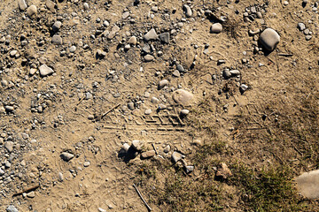 Natural sand stone texture background. Sand texture from heap of sand. Traces of the protectors of heavy industrial machinery on white sand. Background.