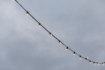 light bulb garlands against the grey sky