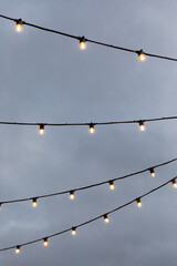 light bulb garlands against the grey sky