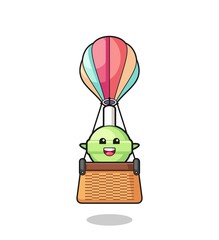 lollipop mascot riding a hot air balloon