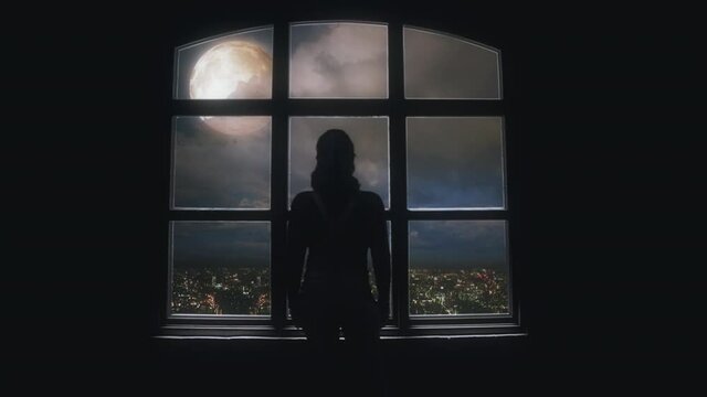 Female Silhouette Looking Full Moon From Window Inside House. Silhouette of an isolated woman looking to the full moon through a big window inside a house. Zoom in