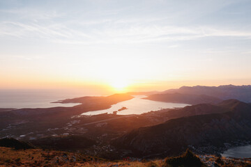 Fototapeta na wymiar Orange rays of the sun over the Bay of Kotor. View from Mount Lovcen