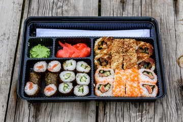 Set of the different sushi on wooden table