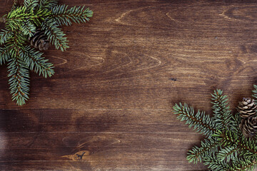 New Year's background. Spruce branches on a wooden table. Ornaments for the New Year tree. Christmas concept.