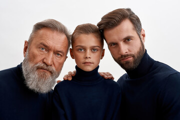Portrait of three generations of men hugging
