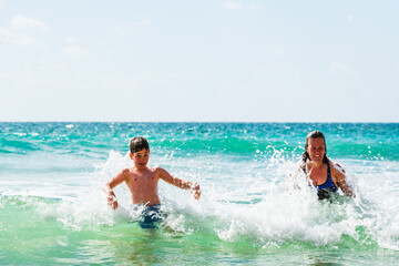 Mother and son playing in sea, Alvor, Algarve, Portugal, Europe