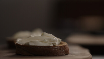 cream cheese on slice of dark ciabatta