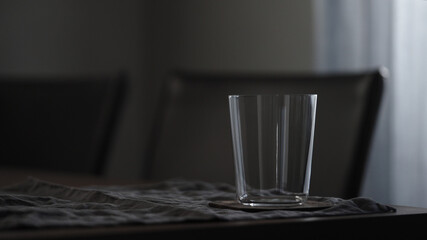 empty tumbler glass on linen cloth
