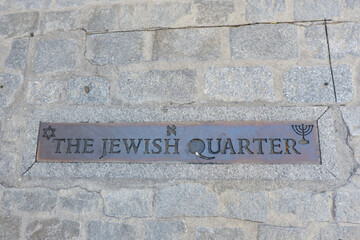Fototapeta premium Metallic sign of jewish quarter written in english language outside on the street in multi cultural historical city of Toledo, Spain