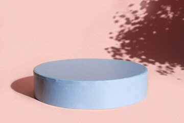 Podium for cosmetic product presentation. Abstract minimal form with geometrical form. Cylinder podium with Floral sunlight shadow. Scene to show products. Showcase, display case. Flat lay, top view