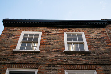 Windows on facade of traditional British brick house in York