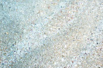 Sandy bottom through clear sea water. Sand backgrounds.