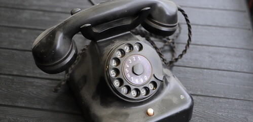 an old dusty black rotary phone 