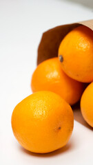 Bright ripe orange oranges in the package on a white background. View from above.