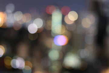Abstract blurred lights city office building downtown background, beautiful cityscape view in night time.
