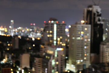 Abstract blurred lights city office building downtown background, beautiful cityscape view in night time.