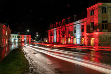 Fototapeta na wymiar Illuminated buildings at night in Rauna, Latvian national holidays.
