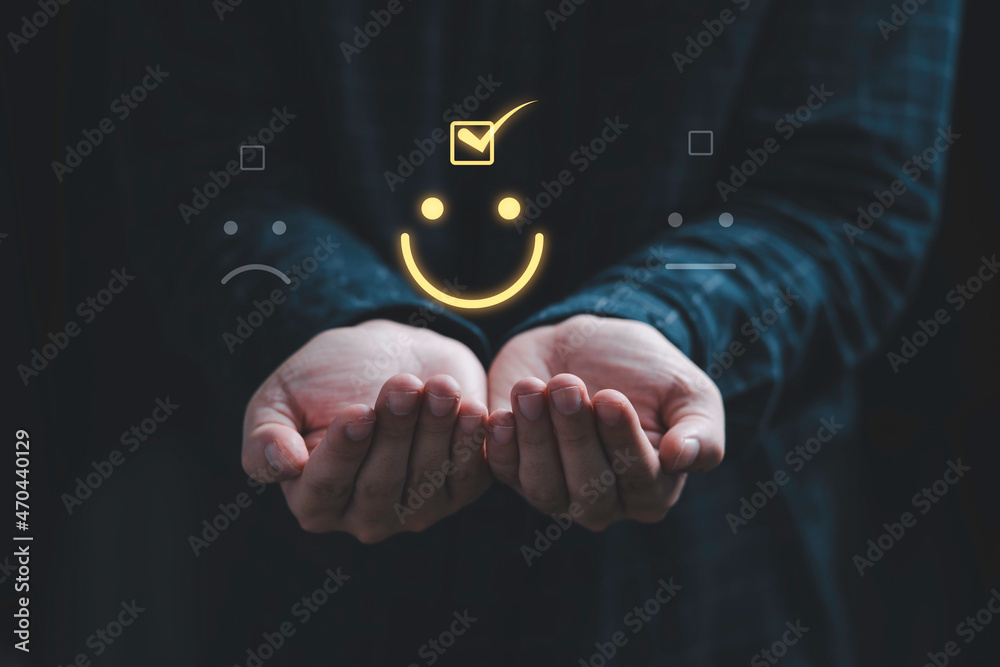 Poster Two hands holding and select smiley face icon for client evaluation and customer satisfaction after use product and service concept.