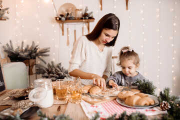 Young parents preparing breakfast with children for christmas