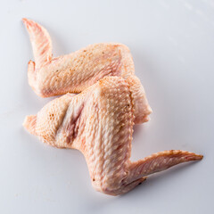 raw turkey wings on a white background