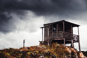 A hunting lodge on the hill in a cloudy moment
