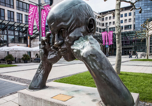 Stuttgart, Germany - modern art in public places: bronze sculpture of a thinking man,  Denkpartner, of year 1980 by Hans-Joerg Limbach in Boersenplatz, city center
