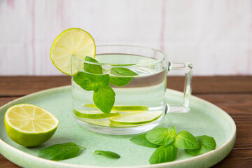 Detox water with mint leaves and lime. Healthy food rich in vitamins and antioxidants.