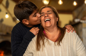 Happy smiling Hispanic grandmother and his grandchild having tender moment together - Family love...