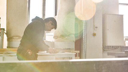Man using a hand saw to cut wood