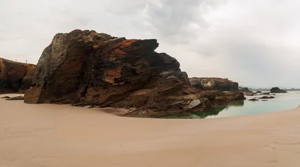 Foto op Canvas Panoramic of an eroded rock on the beach of the cathedrals. © Jhony