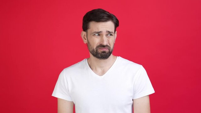 Nervous guy look empty space displeased dirt isolated red color background