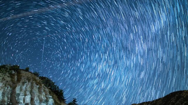 Startrails Above Cliff and Mountains Astrophotography Time Lapse Angeles National Forest California USA