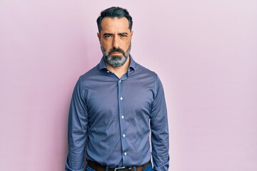 Middle age man with beard and grey hair wearing business clothes depressed and worry for distress, crying angry and afraid. sad expression.