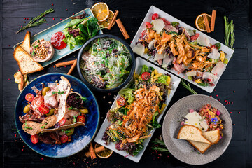 Assorted Chinese food set. Chinese noodles, dim sum, Famous Chinese cuisine dishes on black table. Top view. Chinese restaurant concept. Asian style