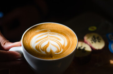Coffee latte art on wooden table