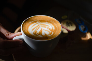 Coffee latte art on wooden table