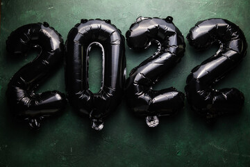foil balloons numeral 2022 with realistic festive objects. Shiny party background. Horizontal banner