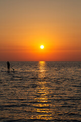 Fototapeta premium Sunrise on the sea island with servers on the sup.