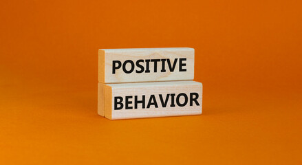 Positive behavior support symbol. Concept words Positive behavior on wooden blocks on a beautiful orange background. Business, psychological and Positive behavior support concept. Copy space.