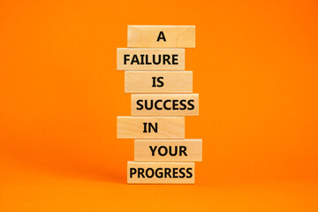 Naklejka premium Failure or success symbol. Wooden blocks with words A failure is success in your progress. Beautiful orange background, copy space. Business, failure or success concept.