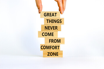 Out from comfort zone symbol. Wooden blocks with words Great things never come from comfort zone. Beautiful white background, copy space. Businessman hand. Business, out from comfort zone concept.