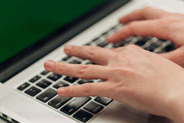 Fototapeta na wymiar Close-Up Shot of Human Hands Placed Over Laptop