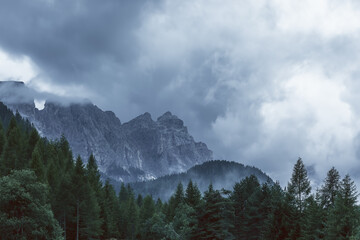 The peaks of the Italian Dolomites are covered with low clouds after heavy rain