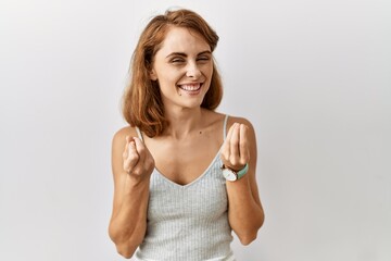 Beautiful caucasian woman standing over isolated background doing money gesture with hands, asking for salary payment, millionaire business