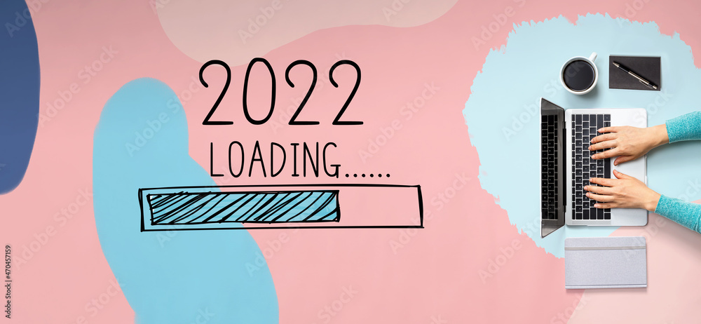Poster loading new year 2022 with person using a laptop computer